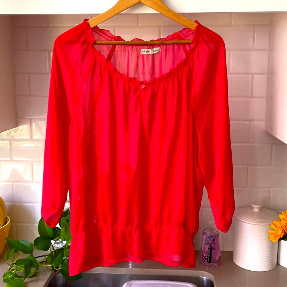 A sheer red shirt is great for this hot summer